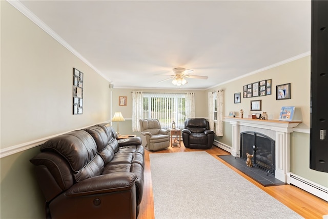 67 Vera St, Warwick, RI 02886 - living room with baseboard heating, wood finished floors, crown molding, a ceiling fan, and a tiled fireplace