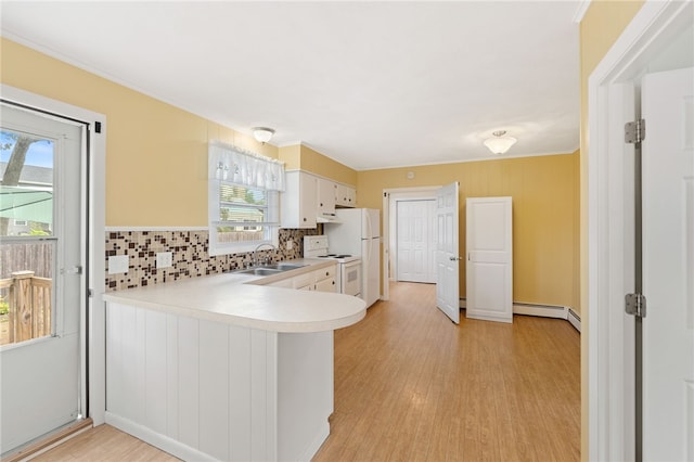 67 Vera St, Warwick, RI 02886 - kitchen with white electric range, a baseboard heating unit, light countertops, backsplash, and healthy amount of natural light