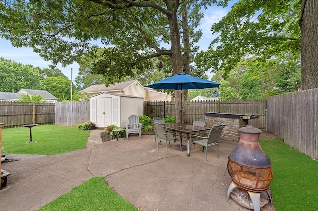 67 Vera St, Warwick, RI 02886 - fenced backyard featuring a fire pit, a patio area, a storage unit, and outdoor dining area