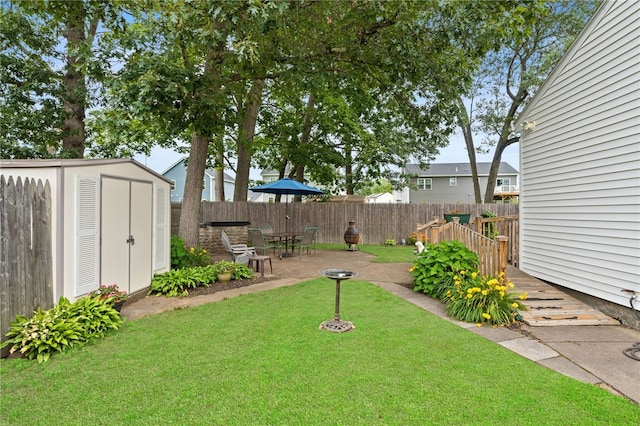 67 Vera St, Warwick, RI 02886 - view of yard featuring a storage unit and a patio area