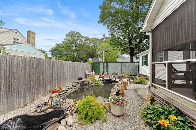 67 Vera St, Warwick, RI 02886 - fenced backyard with a garden pond