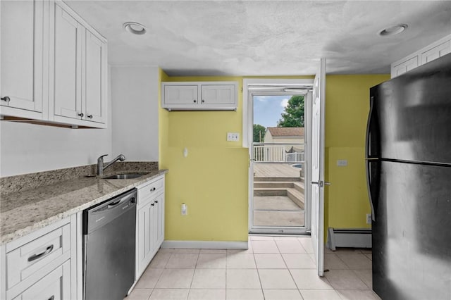 203 Pulaski St, West Warwick, RI 02893 - kitchen featuring dishwasher, freestanding refrigerator, a baseboard heating unit, and white cabinets