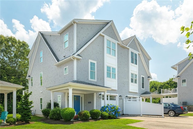 100 Algonquin Rd Unit 13, Narragansett, RI 02882 - view of front of house featuring a garage and a front lawn
