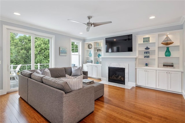 100 Algonquin Rd Unit 13, Narragansett, RI 02882 - living room with crown molding, light wood-style floors, a ceiling fan, a fireplace, and recessed lighting