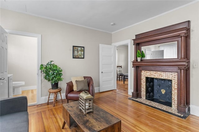 1413 Broad St, Providence, RI 02905 - living area featuring wood finished floors, crown molding, and a fireplace