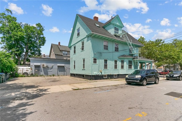 1413 Broad St, Providence, RI 02905 - view of side of property featuring a chimney and roof with shingles