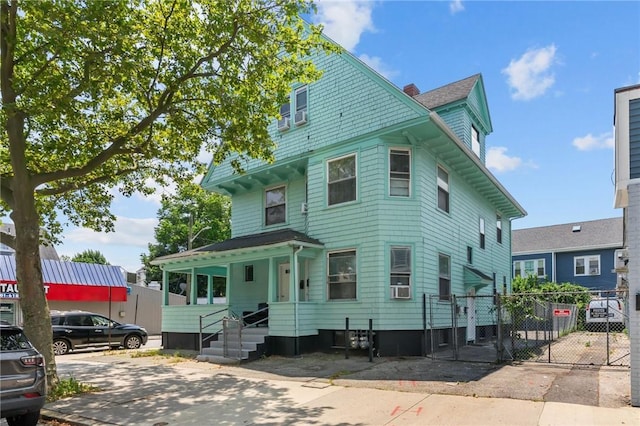 1413 Broad St, Providence, RI 02905 - victorian home with a gate, cooling unit, and a chimney