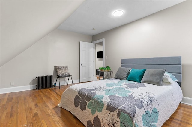 1413 Broad St, Providence, RI 02905 - bedroom with radiator, wood finished floors, and vaulted ceiling