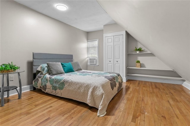 1413 Broad St, Providence, RI 02905 - bedroom featuring wood finished floors, vaulted ceiling, a closet, and cooling unit