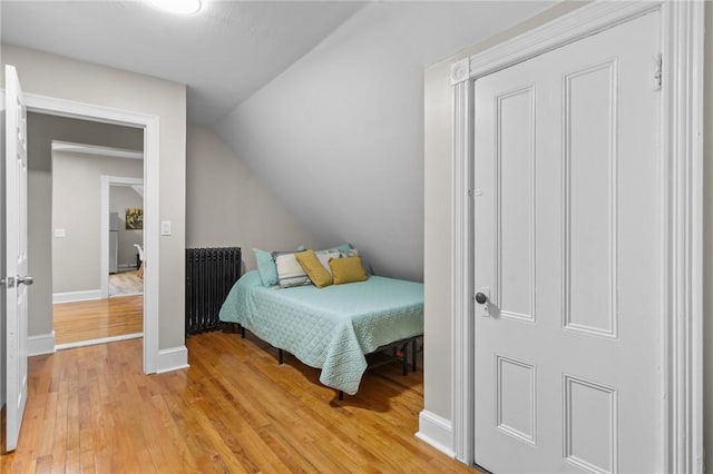 1413 Broad St, Providence, RI 02905 - bedroom with radiator heating unit, light wood-style floors, and lofted ceiling