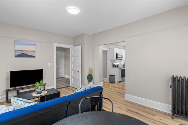 1413 Broad St, Providence, RI 02905 - living area featuring radiator and light wood finished floors