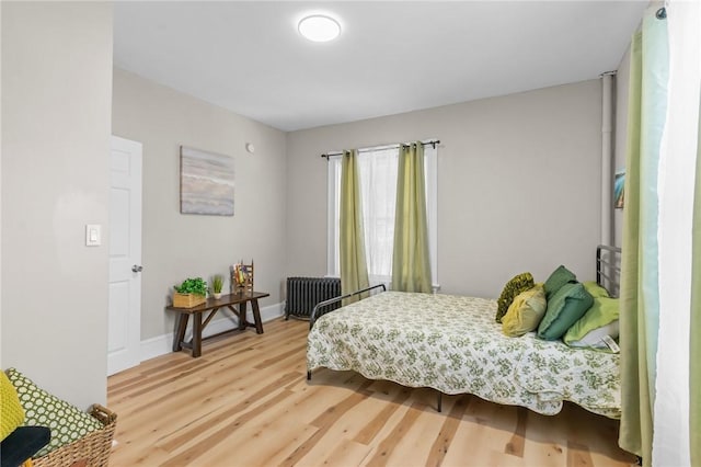 1413 Broad St, Providence, RI 02905 - bedroom with radiator and light wood-type flooring