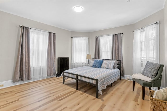 1413 Broad St, Providence, RI 02905 - bedroom with radiator heating unit and light wood-type flooring