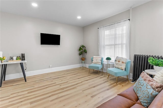 1413 Broad St, Providence, RI 02905 - living area featuring radiator, wood finished floors, and recessed lighting
