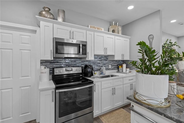 406 Cahill St, Providence, RI 02905 - kitchen with appliances with stainless steel finishes, tasteful backsplash, white cabinetry, recessed lighting, and light wood-style flooring