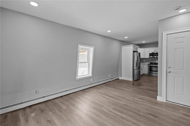 406 Cahill St, Providence, RI 02905 - unfurnished living room featuring a baseboard radiator, light wood-style floors, and recessed lighting