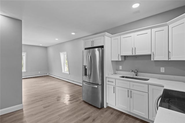406 Cahill St, Providence, RI 02905 - kitchen featuring stainless steel fridge, white cabinetry, light countertops, and recessed lighting