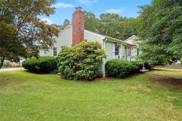 2 Glen Dr, Warwick, RI 02889 - view of home's exterior with a lawn and a chimney