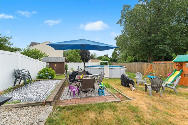 2 Glen Dr, Warwick, RI 02889 - fenced backyard featuring a shed, a playground, and a patio