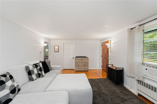 2 Glen Dr, Warwick, RI 02889 - living room featuring radiator heating unit, arched walkways, and light wood-type flooring