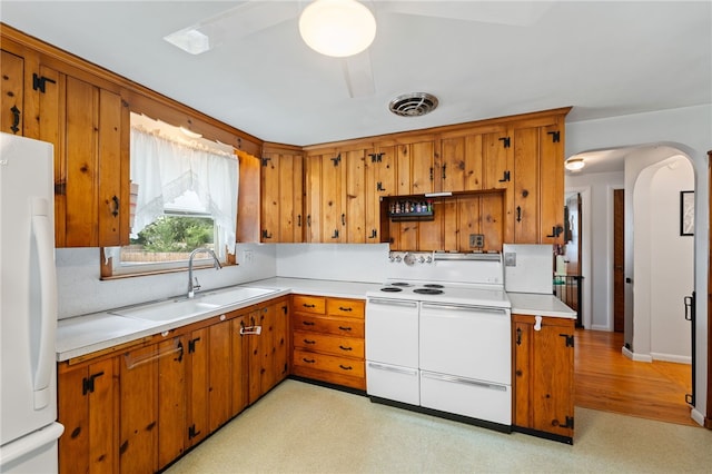 2 Glen Dr, Warwick, RI 02889 - kitchen featuring white appliances, arched walkways, and brown cabinets