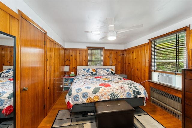 2 Glen Dr, Warwick, RI 02889 - bedroom with wood finished floors, cooling unit, wooden walls, and ceiling fan