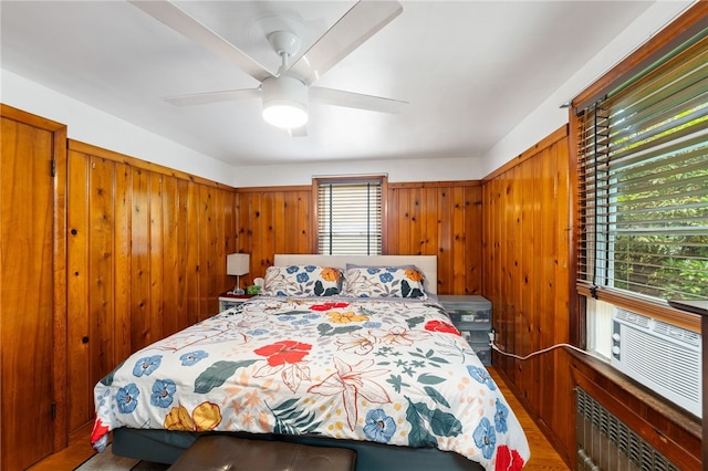 2 Glen Dr, Warwick, RI 02889 - bedroom with wood walls, a ceiling fan, radiator heating unit, and wood finished floors