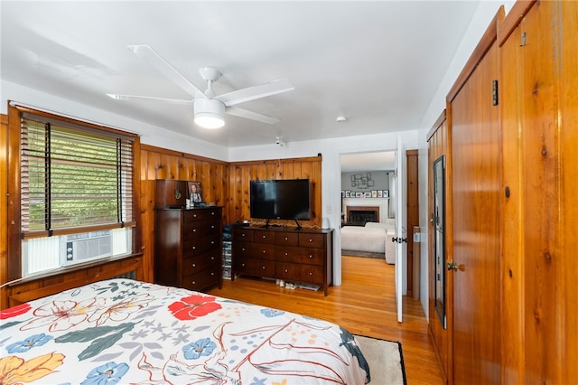 2 Glen Dr, Warwick, RI 02889 - bedroom with light wood-type flooring, a closet, a ceiling fan, and a fireplace