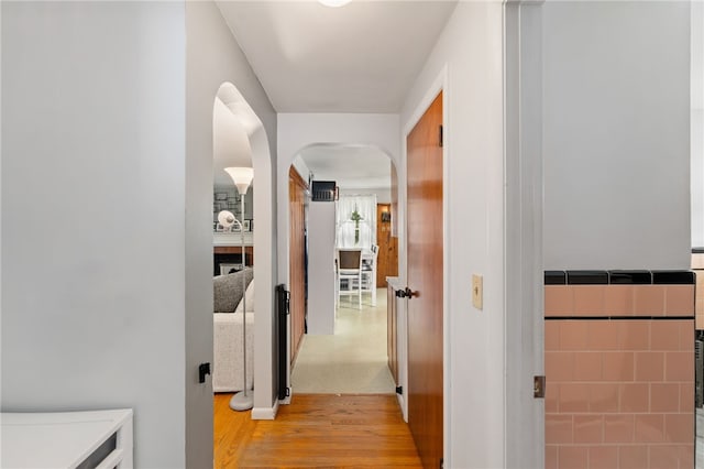 2 Glen Dr, Warwick, RI 02889 - corridor featuring arched walkways and light wood-style floors