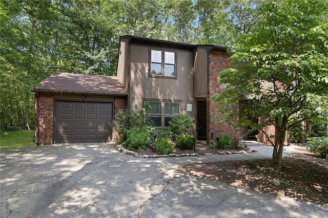 26 Pheasant Run Unit A, Smithfield, RI 02917 - view of front of house featuring a garage, driveway, and brick siding