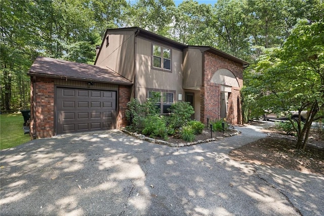 26 Pheasant Run Unit A, Smithfield, RI 02917 - view of front of house featuring asphalt driveway, brick siding, and an attached garage