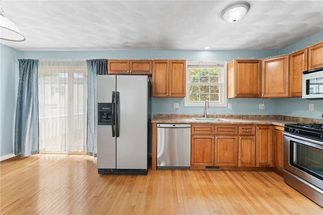 174 Long St, Warwick, RI 02886 - kitchen featuring stainless steel appliances, brown cabinets, and light wood-style floors