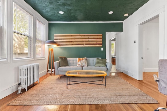 61 Wealth Ave, Providence, RI 02908 - living room featuring radiator heating unit, plenty of natural light, wood finished floors, and recessed lighting