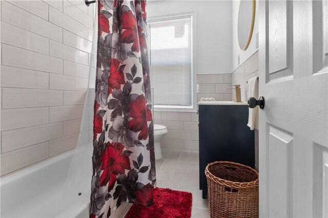 61 Wealth Ave, Providence, RI 02908 - bathroom with tile walls, tile patterned flooring, vanity, shower / tub combo, and a wainscoted wall