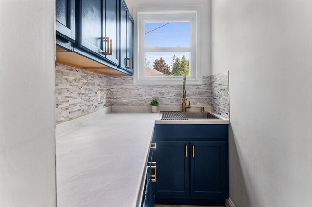 61 Wealth Ave, Providence, RI 02908 - kitchen with blue cabinets, light countertops, and tasteful backsplash