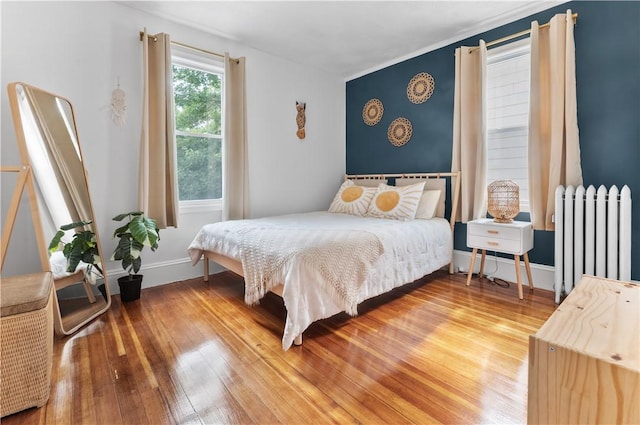 61 Wealth Ave, Providence, RI 02908 - bedroom with radiator heating unit and wood finished floors