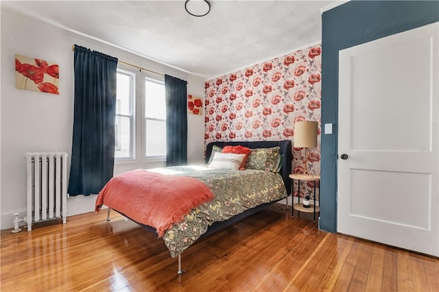 61 Wealth Ave, Providence, RI 02908 - bedroom with radiator, wallpapered walls, and wood-type flooring