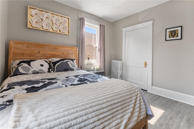 61 Wealth Ave, Providence, RI 02908 - bedroom featuring radiator heating unit and wood finished floors