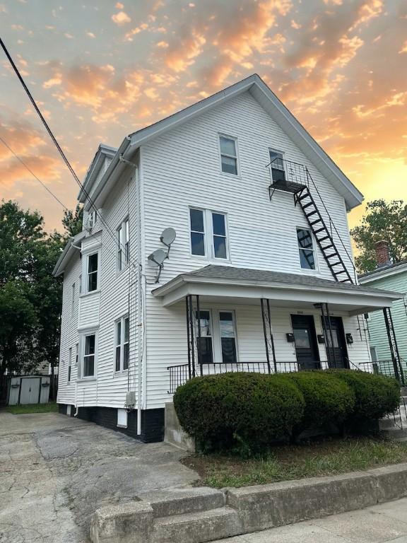 208 Carnation St, Pawtucket, RI 02860 - view of front facade featuring a porch and a storage unit