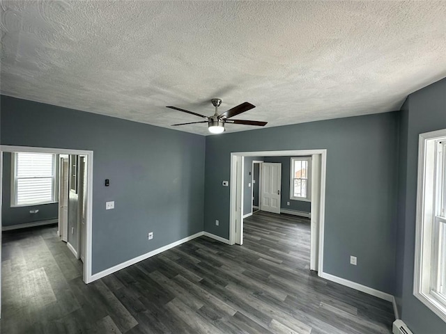 208 Carnation St, Pawtucket, RI 02860 - spare room featuring a textured ceiling, a ceiling fan, plenty of natural light, and dark wood-style floors