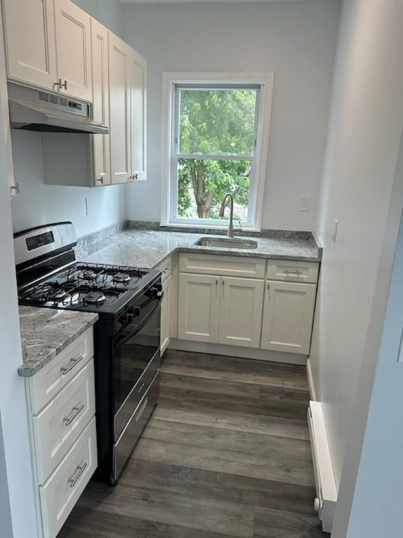 208 Carnation St, Pawtucket, RI 02860 - kitchen featuring stainless steel gas range, under cabinet range hood, dark wood-style flooring, and white cabinets