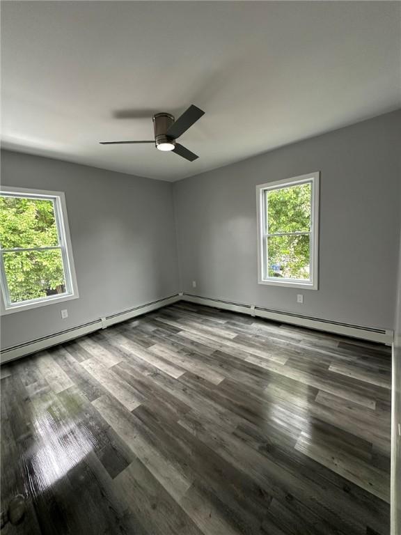 208 Carnation St, Pawtucket, RI 02860 - unfurnished room with wood finished floors, ceiling fan, and a baseboard heating unit