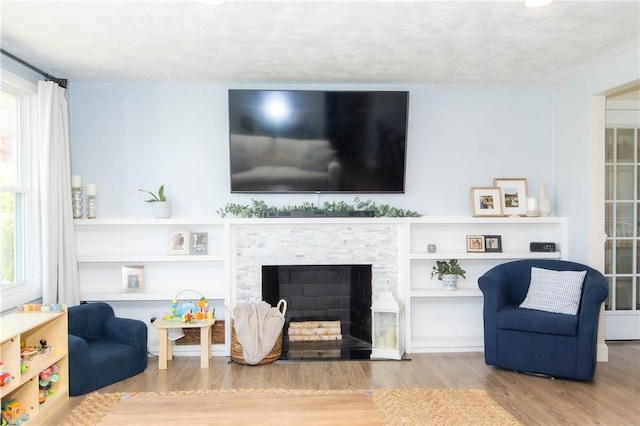94 Osage Dr, Warwick, RI 02888 - living area with wood finished floors and a stone fireplace