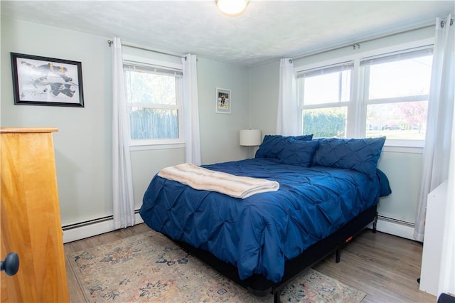 94 Osage Dr, Warwick, RI 02888 - bedroom with baseboard heating, wood finished floors, and multiple windows