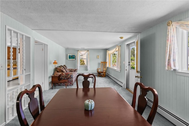 33 Limestone St, Warwick, RI 02889 - dining room featuring a baseboard heating unit, carpet flooring, and a textured ceiling