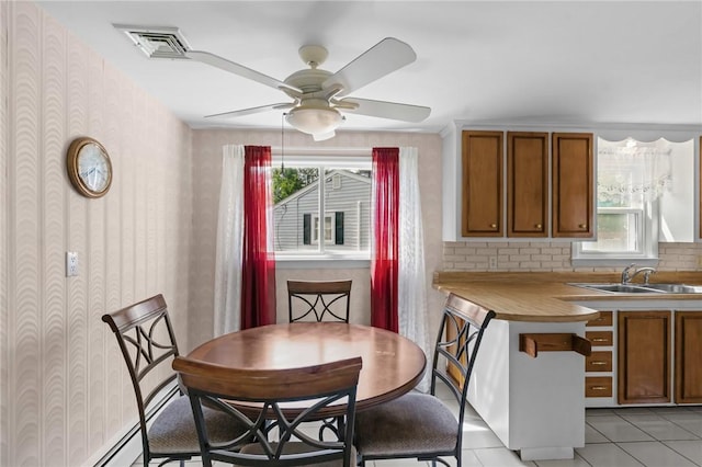 33 Limestone St, Warwick, RI 02889 - dining area with a ceiling fan, light tile patterned floors, and wallpapered walls