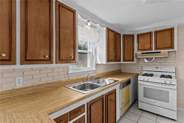 33 Limestone St, Warwick, RI 02889 - kitchen with white range with gas stovetop, under cabinet range hood, dishwashing machine, light countertops, and light tile patterned floors