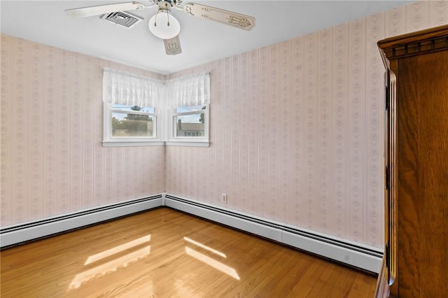 33 Limestone St, Warwick, RI 02889 - spare room with wood finished floors, a ceiling fan, and a baseboard radiator