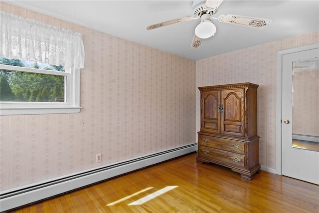 33 Limestone St, Warwick, RI 02889 - bedroom with a baseboard radiator, light wood-type flooring, and a ceiling fan