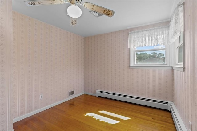 33 Limestone St, Warwick, RI 02889 - spare room with a baseboard radiator, wood finished floors, and ceiling fan
